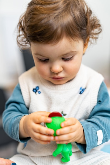 Portret van een grappig kind dat met speelgoed speelt Schattig klein meisje dat plezier heeft