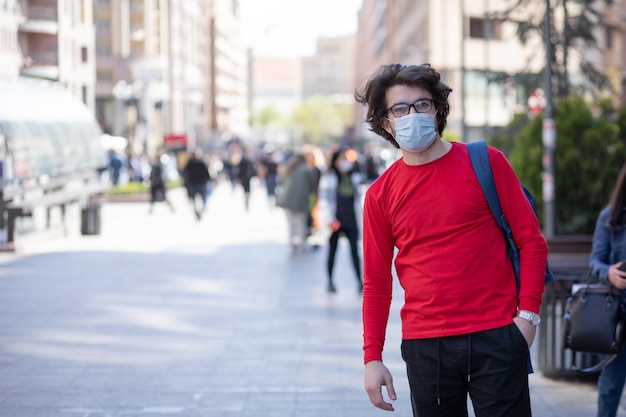 Portret van een jonge knappe blanke man met bril en een masker