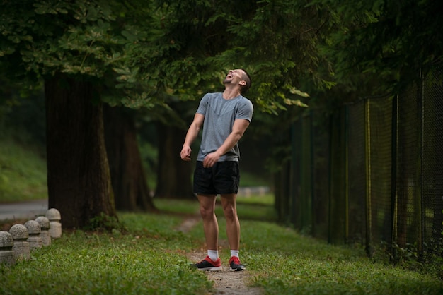 Portret van een jonge man die buitenactiviteiten doet rennen - lachen