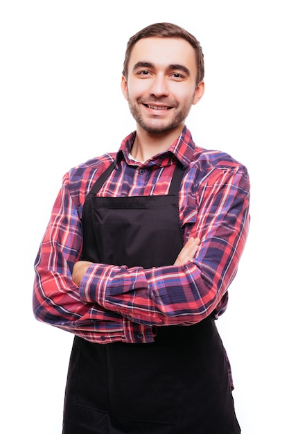 Portret van een jonge man met een zwarte schort op een witte muur