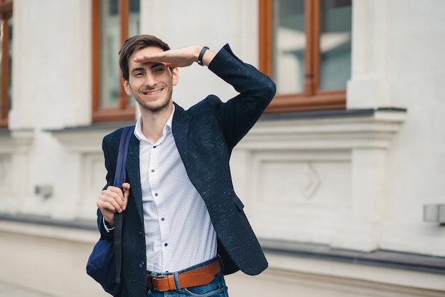 Portret van een jonge man met rugzak die een vriend zag