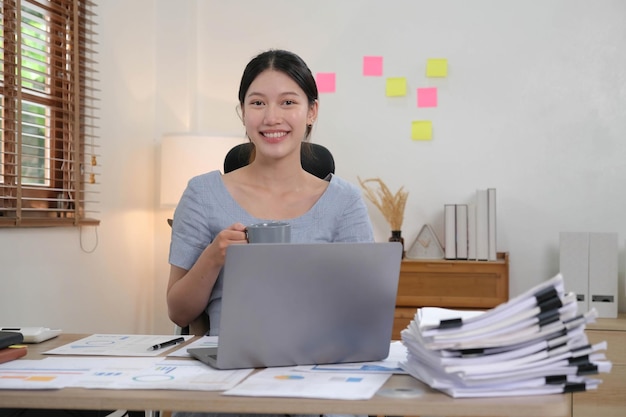 Portret van een jonge vrouw die een laptop gebruikt op kantoor Student meisje dat thuis werkt Werk of studeer vanuit huis Aziatische vrouw freelance zakelijke levensstijl concept