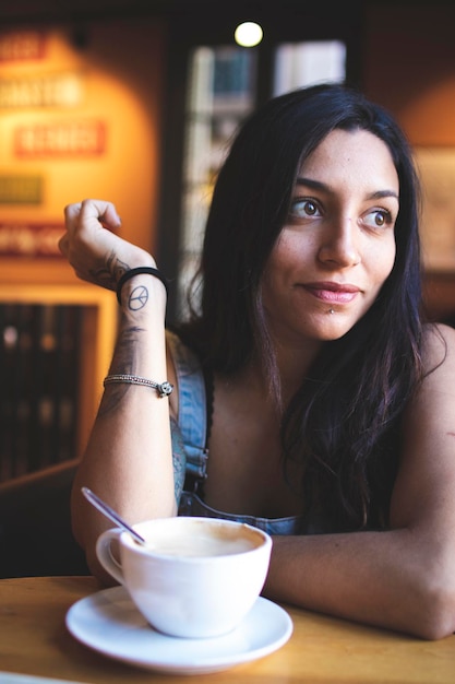 Portret van een jonge vrouw die in een café zit