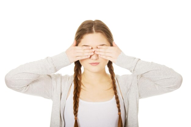 Foto portret van een jonge vrouw die tegen een witte achtergrond staat