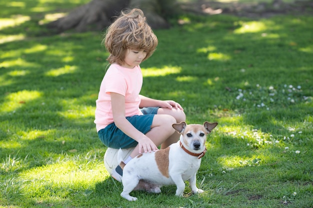 Portret van een kind jongen speelt met een hond buiten kind streel hond