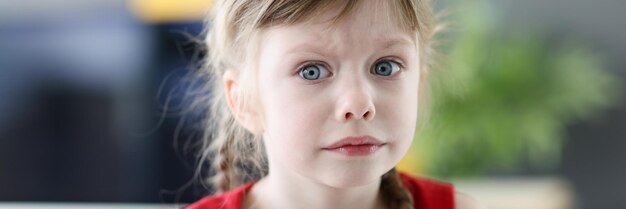 Portret van een klein emotioneel meisje met een peinzend bange blik close-up