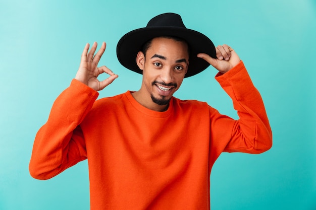 Portret van een lachende jonge Afro-Amerikaanse man in hoed