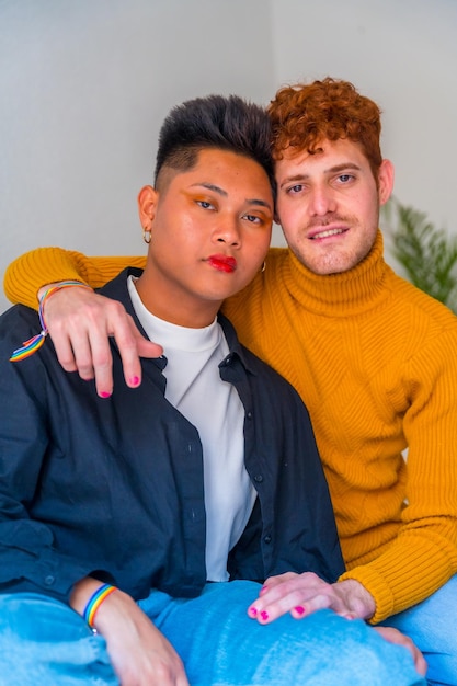 Foto portret van een mooi homopaar in make-up die binnenshuis thuis lgbt-concept glimlacht