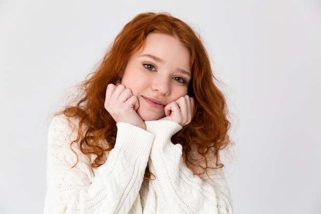 Portret van een mooi jong roodharig meisje status geïsoleerd op witte achtergrond