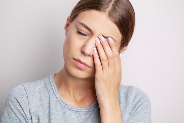 Portret van een mooi ziek meisje dat lijdt aan migraine, gevoelens van druk en stress