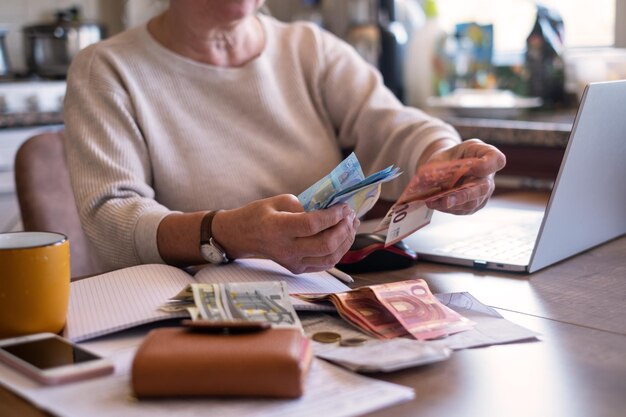 Portret van een oude vrouw die geld telt