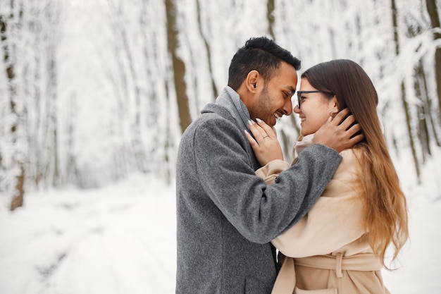 Portret van een romantisch stel dat samen tijd doorbrengt in het winterbos