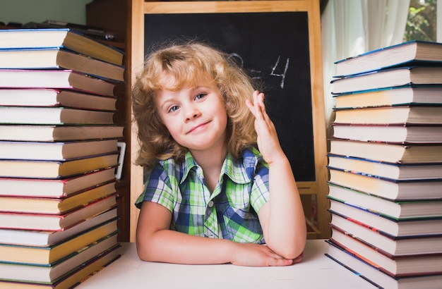 Portret van een schattig schoolmeisje dat de hand opsteekt en het antwoord op de vraag kent