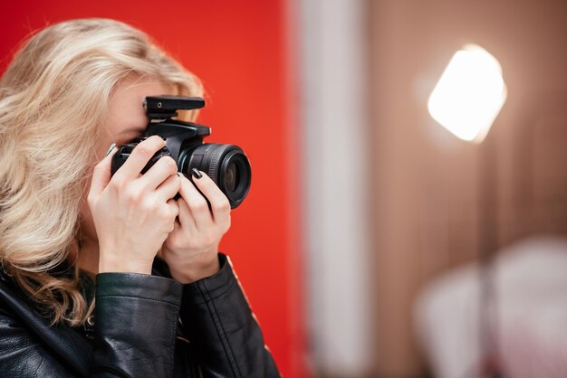 Portret van een schattige meisjesfotograaf die foto's maakt in een fotostudio