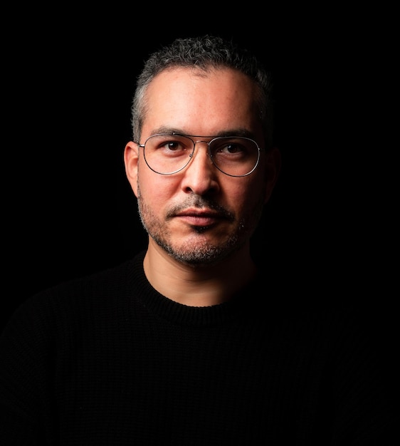 Portret van een volwassen man tegen een zwarte achtergrond