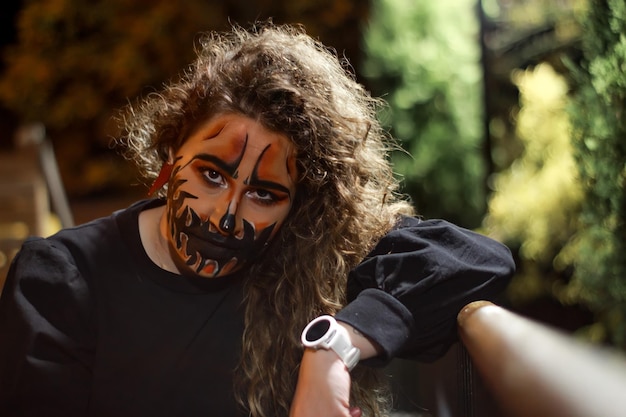 Portret van een vrouw in make-up en kostuum op Halloween-avond in de straat