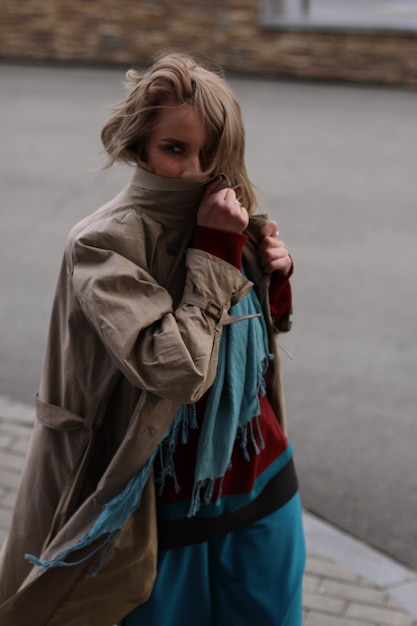 Portret van een vrouw in warme kleding die op de stoep loopt