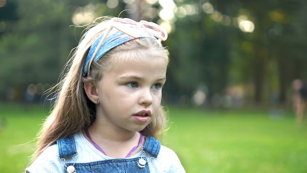 Portret van gelukkig mooi kind meisje in de zomer buiten.