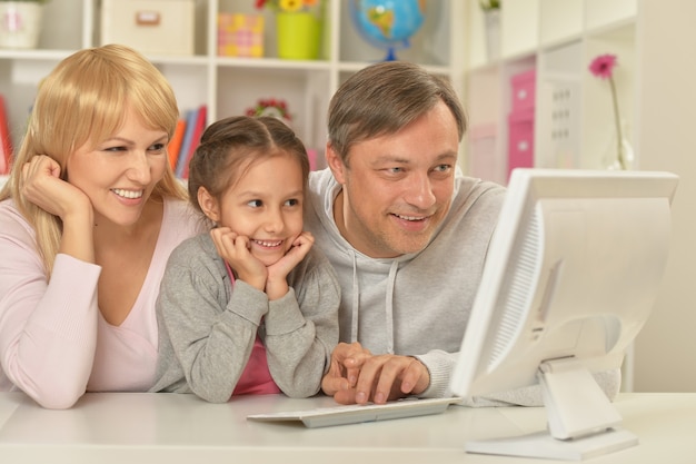 Portret van gelukkige familie die thuis op de computer speelt