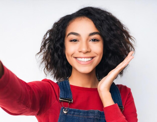 Portret van glimlachende vrouw maakt selfie met de camera op een geïsoleerde witte achtergrond met een grote glimlach op c