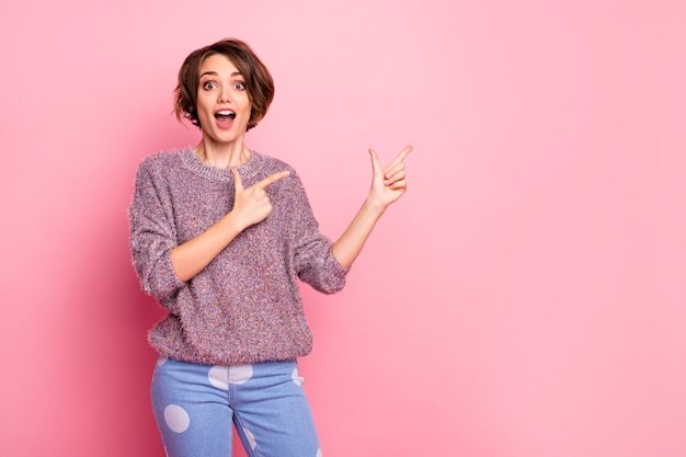 Portret van haar ze mooi aantrekkelijk mooi charmant opgewonden verbaasd vrolijk blij bruinharig meisje toont advies oplossing besluit advertentie geïsoleerd over roze pastelkleur muur