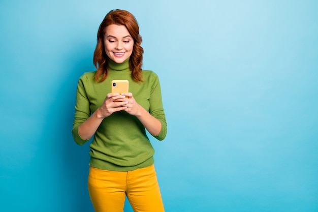 Portret van haar ze mooi aantrekkelijk mooi vrolijk vrolijk verslaafd meisje met golvend haar gebruikt 5g app celservice geïsoleerd over heldere levendige glans levendig blauw turkoois groenblauw kleur muur