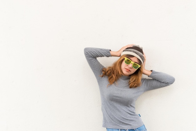 Portret van hipster meisje op witte muur levensstijl van moderne tiener Cool hipster student vrouw met brillenglazen