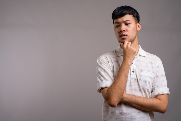 Portret van jonge Aziatische man denken en plannen