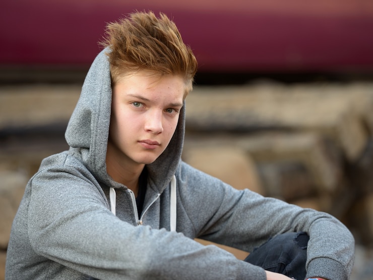 Foto portret van jonge knappe tiener bij het treinstation