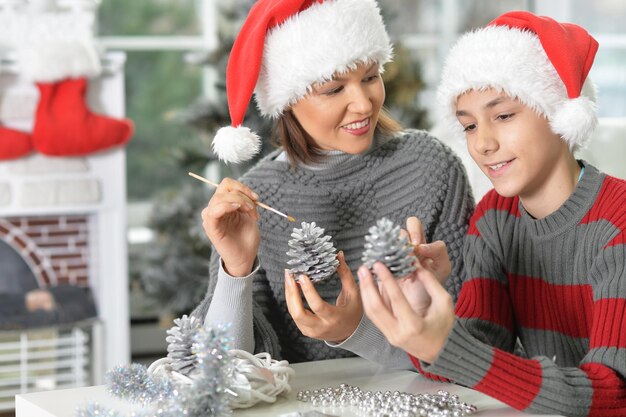 Portret van jonge moeder met zoon die zich voorbereidt op Kerstmis