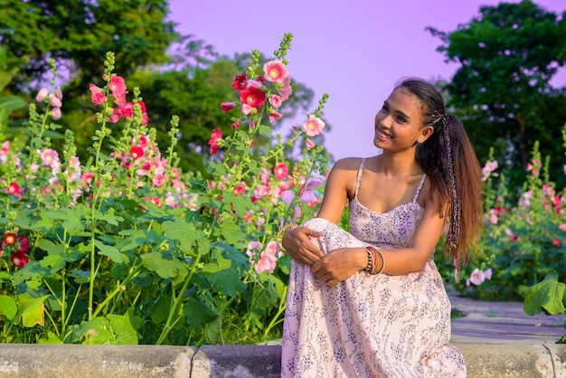 Portret van jonge mooie Aziatische vrouw ontspannen in het park