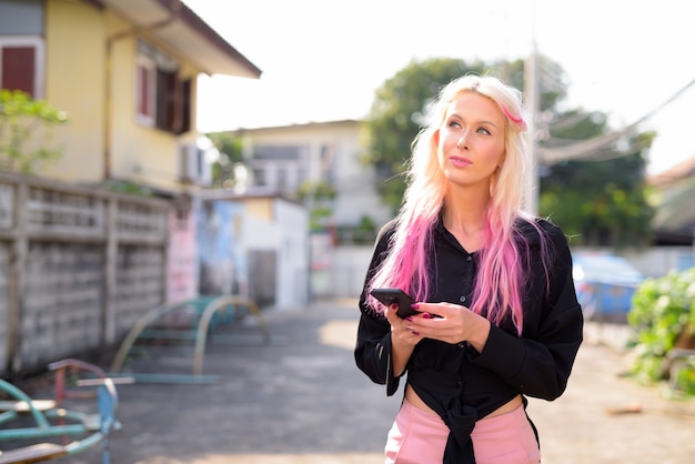 portret van jonge mooie blonde vrouw het verkennen van de straten van de stad buitenshuis