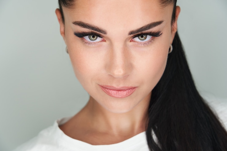 Foto portret van jonge mooie vrouw met donker haar en lange wimpers
