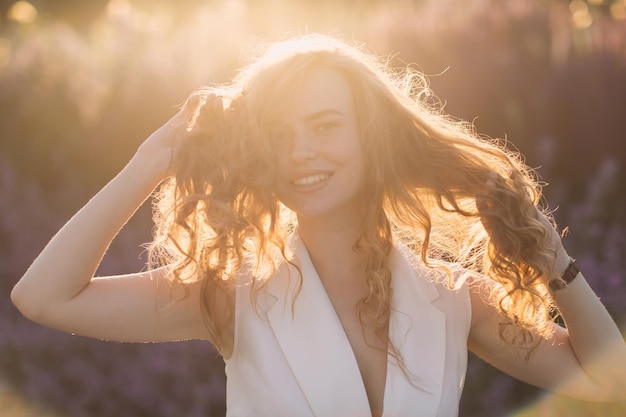 Portret van jonge positieve vrouw met krullend haar