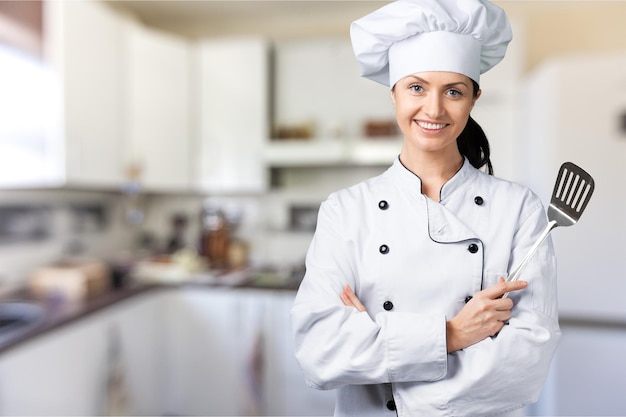 Portret van jonge vrouwenchef-kok op background