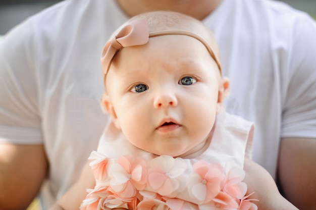 Portret van kleine schattige baby meisje in handen van de vader