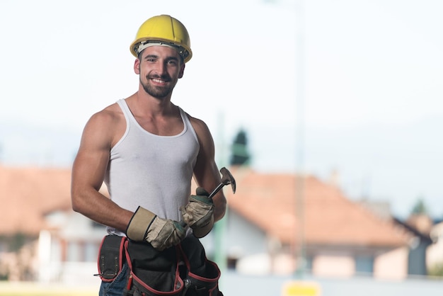 Portret van knappe mannelijke architect-ingenieur met gele helm