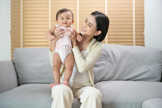 Portret van moeder en babymeisje thuis familie kind jeugd en ouderschap concept