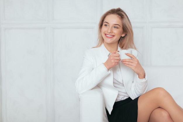 Portret van mooie jonge vrouw die op kantoor werkt.