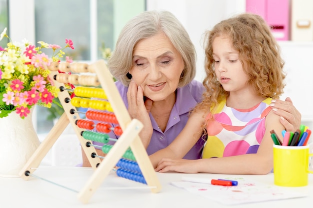 Portret van oma en kleindochter die huiswerk maken