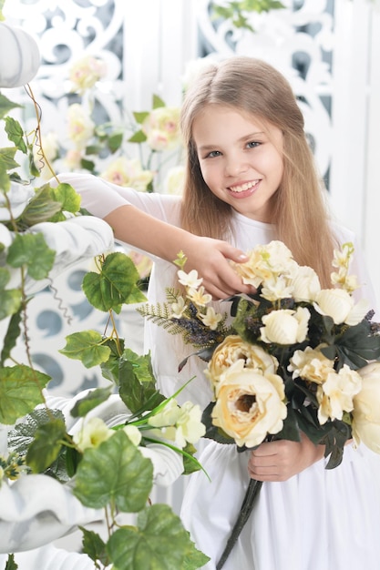 Portret van schattig klein meisje poseren met bloemen