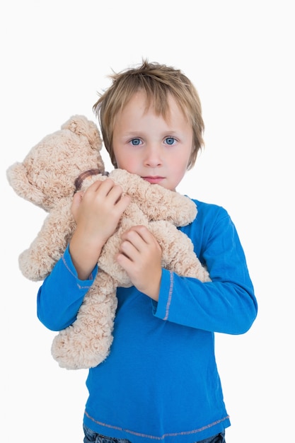 Portret van schattige jonge jongen knuffelen teddybeer