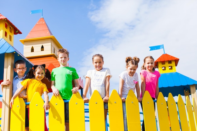 Portret van schattige kinderen op de speeltuin tegen de lucht