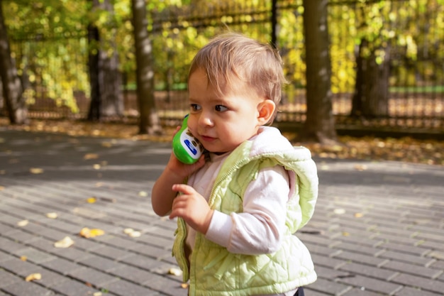 portret van schattige peuter spelen praten op een speelgoed telefoon.