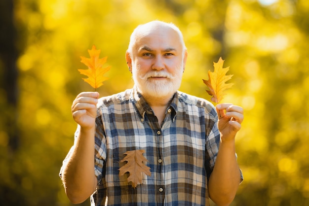 Portret van senior man met bladeren in een bos