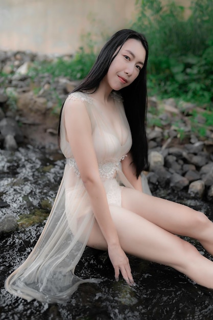 Portret van sexy aziatische vrouw bij de waterval Fris voelen aan de rivierThaise vrouw ontspant zich op het platteland