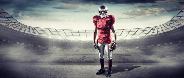 Portret van sportman met Amerikaans voetbal tegen rugbystadion