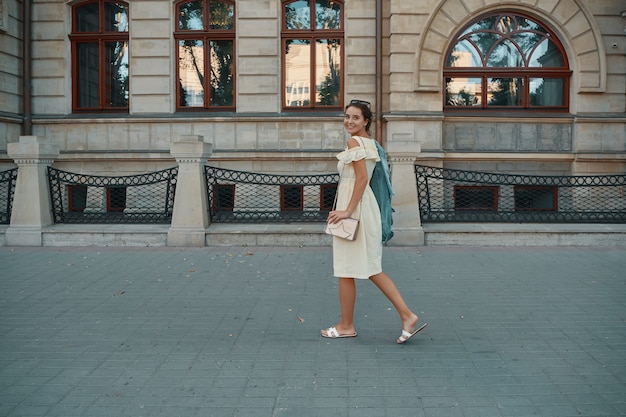 Portret van stijlvolle lachende, gelukkig brunette vrouw lopen op straat