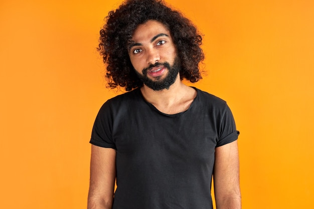 Portret van tevreden Arabische man geïsoleerd in de studio, knappe jongen in vrijetijdskleding poseren