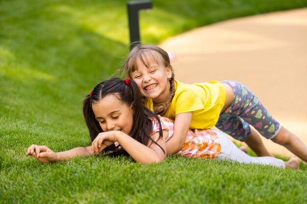 Portret van twee kleine meisjeszusters die vechten op de achtertuin van het huis. vrienden meisjes plezier. lifestyle openhartig familiemoment van broers en zussen die ruzie maken om samen te spelen.
